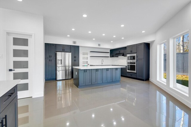 12564 Memorial Dr, Houston, TX 77024 - kitchen with stainless steel appliances, light tile patterned floors, open shelves, light countertops, and recessed lighting