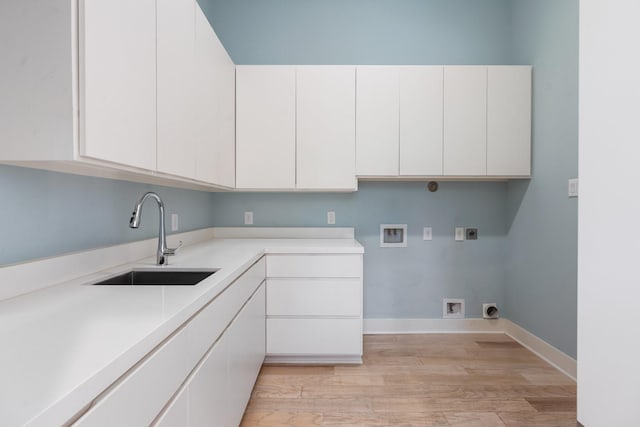 16827 Falcon Sound Dr, Montgomery, TX 77356 - laundry room with electric dryer hookup, washer hookup, light wood-type flooring, cabinet space, and baseboards