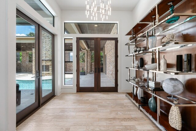 16827 Falcon Sound Dr, Montgomery, TX 77356 - entryway with french doors, wood finished floors, healthy amount of natural light, and a chandelier