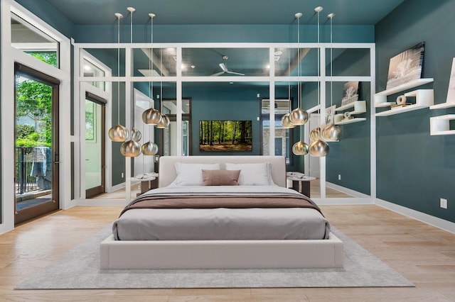 16827 Falcon Sound Dr, Montgomery, TX 77356 - bedroom featuring access to exterior and wood finished floors