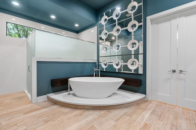 16827 Falcon Sound Dr, Montgomery, TX 77356 - full bath with a freestanding bath, wood finished floors, and recessed lighting