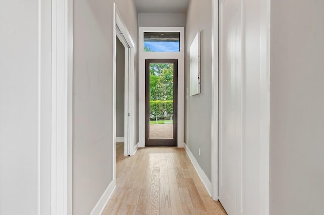 16827 Falcon Sound Dr, Montgomery, TX 77356 - doorway to outside featuring light wood-style floors and baseboards