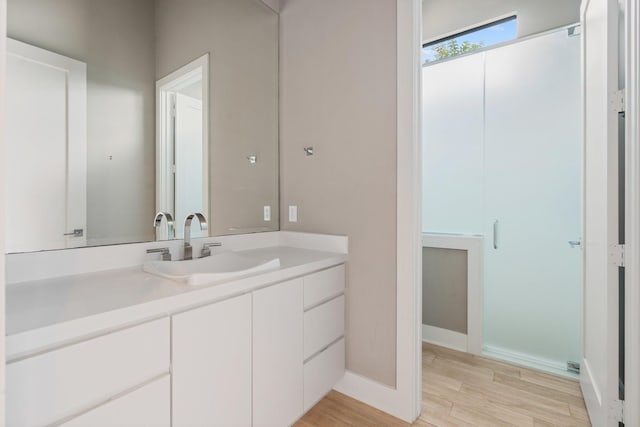 16827 Falcon Sound Dr, Montgomery, TX 77356 - bathroom with vanity, wood finished floors, and baseboards