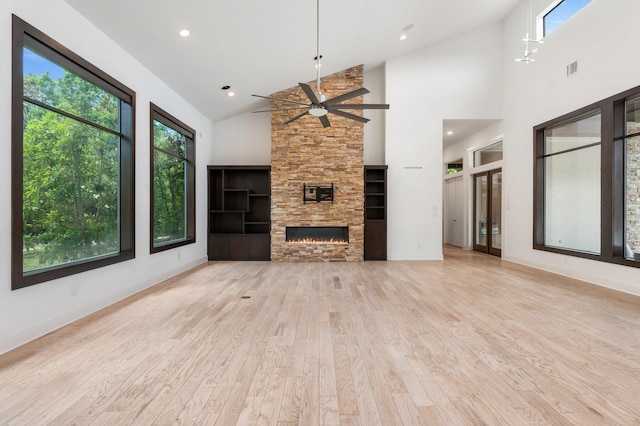 16827 Falcon Sound Dr, Montgomery, TX 77356 - unfurnished living room featuring light wood-style flooring, ceiling fan, a fireplace, high vaulted ceiling, and recessed lighting