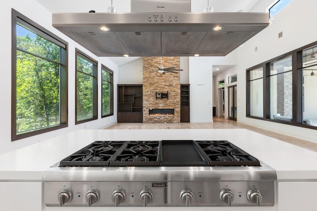 16827 Falcon Sound Dr, Montgomery, TX 77356 - kitchen featuring ventilation hood, stainless steel gas stovetop, a ceiling fan, lofted ceiling, and recessed lighting