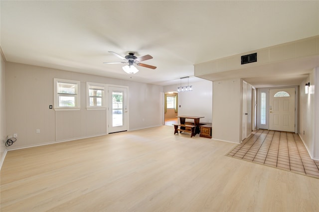 1402 Beachcomber Ln, Houston, TX 77062 - entrance foyer with light wood-type flooring, ceiling fan, baseboards, and a chandelier