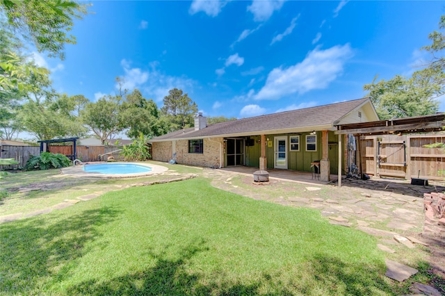 1402 Beachcomber Ln, Houston, TX 77062 - back of house with a chimney, a patio, board and batten siding, an outdoor fire pit, and a gate