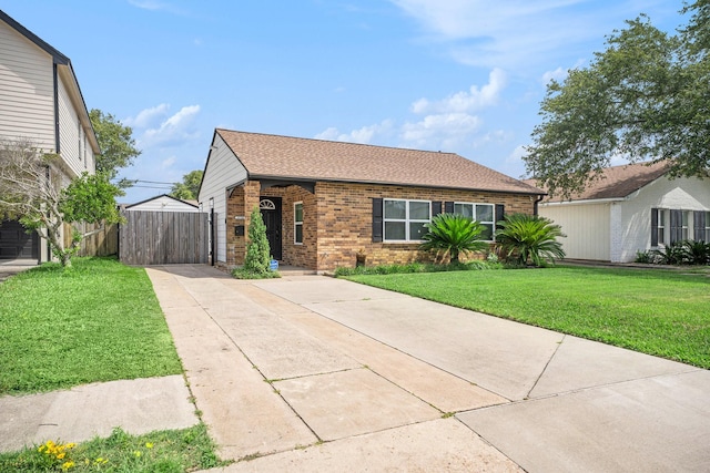 5720 Fraser Ave, Galveston, TX 77551 - ranch-style house featuring brick siding, driveway, a shingled roof, and a gate