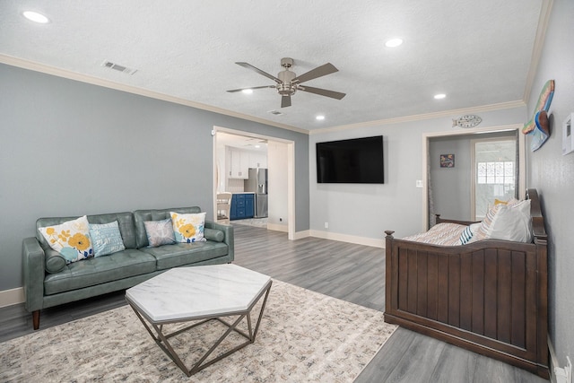 5720 Fraser Ave, Galveston, TX 77551 - living room with ceiling fan, wood finished floors, ornamental molding, baseboards, and recessed lighting
