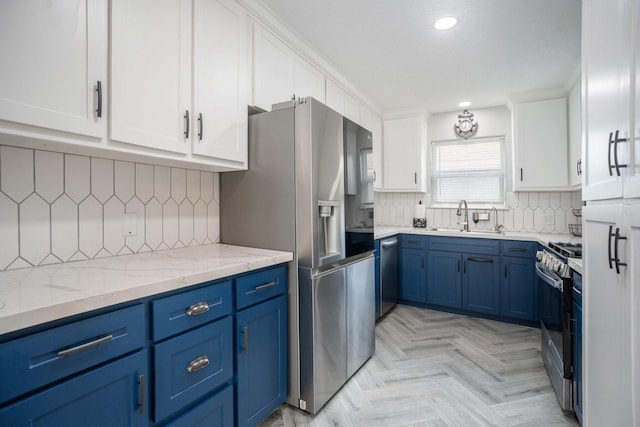 5720 Fraser Ave, Galveston, TX 77551 - kitchen with blue cabinetry, appliances with stainless steel finishes, a sink, white cabinetry, and recessed lighting