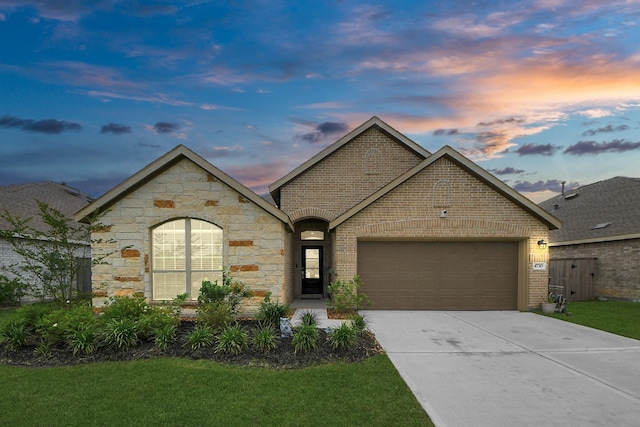 4710 Jasmine Heather Ln, Baytown, TX 77521 - french provincial home with an attached garage, concrete driveway, brick siding, and stone siding