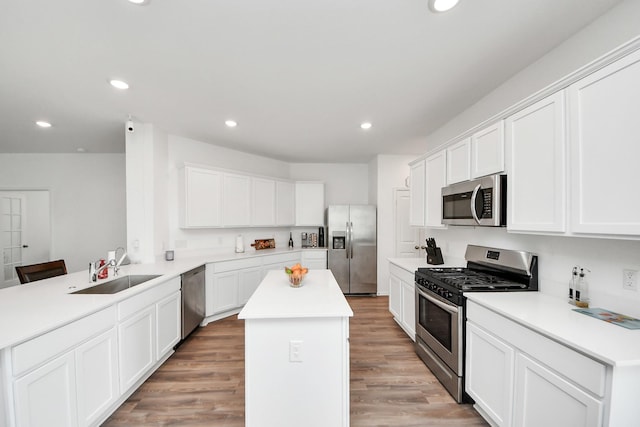 4710 Jasmine Heather Ln, Baytown, TX 77521 - kitchen with appliances with stainless steel finishes, a sink, a peninsula, a center island, and light countertops
