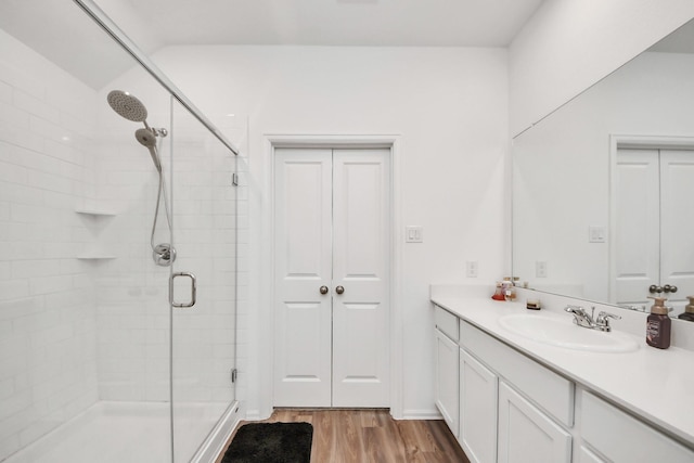 4710 Jasmine Heather Ln, Baytown, TX 77521 - bathroom featuring a stall shower, vanity, and wood finished floors