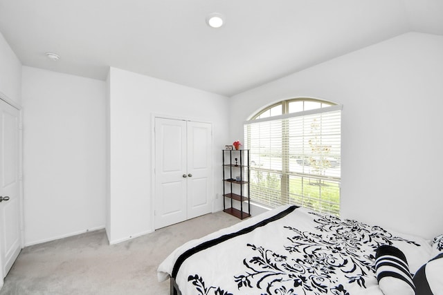 4710 Jasmine Heather Ln, Baytown, TX 77521 - bedroom with light colored carpet, a closet, baseboards, and lofted ceiling