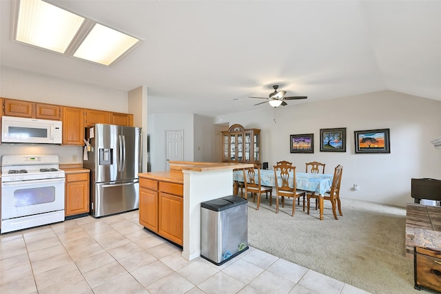 6511 Coldstream Dr, Pasadena, TX 77505 - kitchen featuring white appliances, a ceiling fan, lofted ceiling, light carpet, and light tile patterned floors