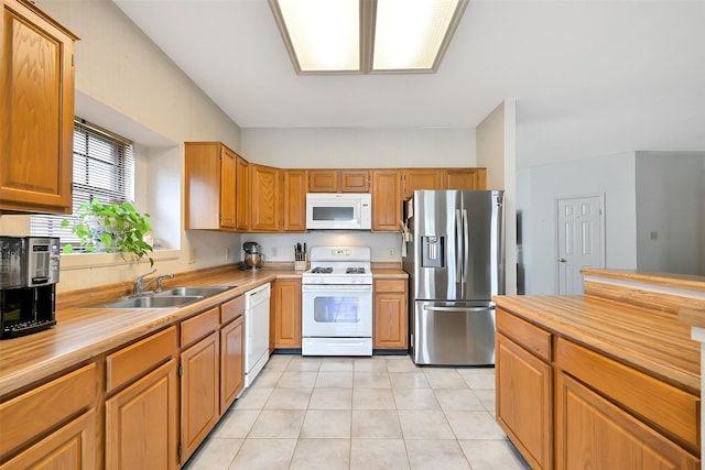 6511 Coldstream Dr, Pasadena, TX 77505 - kitchen featuring white appliances, a sink, light countertops, and light tile patterned flooring