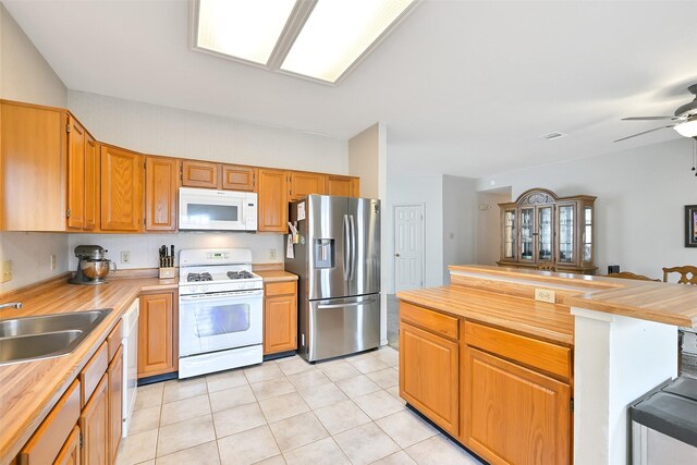 6511 Coldstream Dr, Pasadena, TX 77505 - kitchen with white appliances, a sink, wooden counters, light tile patterned floors, and ceiling fan
