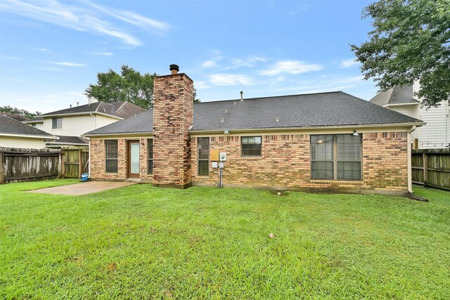 6511 Coldstream Dr, Pasadena, TX 77505 - back of house with roof with shingles, a patio area, a chimney, and brick siding