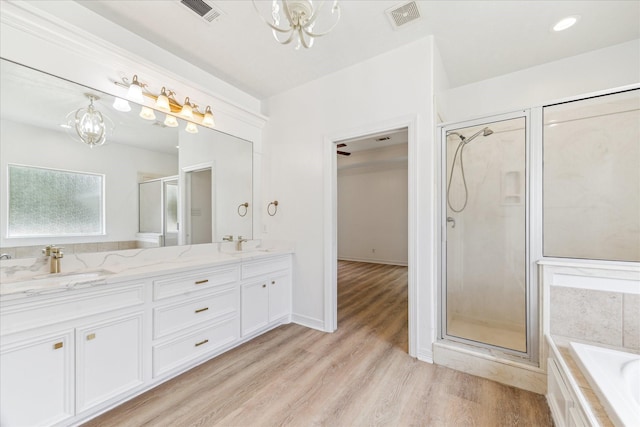 22313 Baneberry Rd, Magnolia, TX 77355 - full bath with a chandelier, a stall shower, double vanity, and a garden tub