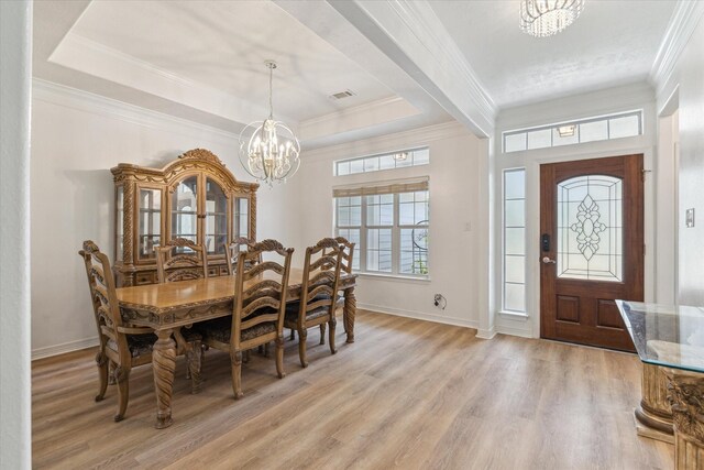 22313 Baneberry Rd, Magnolia, TX 77355 - dining area featuring a chandelier, light wood-style floors, crown molding, baseboards, and a raised ceiling