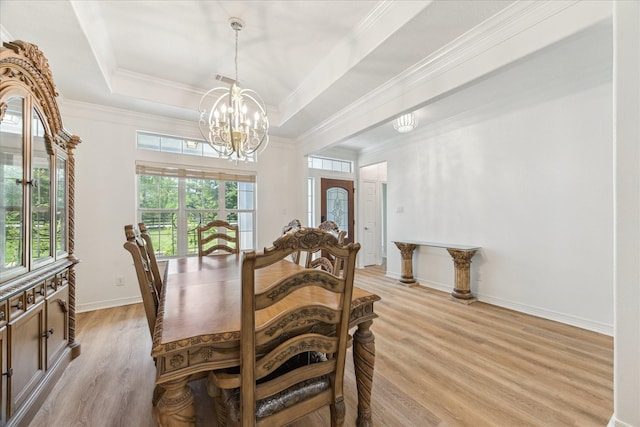 22313 Baneberry Rd, Magnolia, TX 77355 - dining area featuring light wood-type flooring, a tray ceiling, a chandelier, crown molding, and baseboards