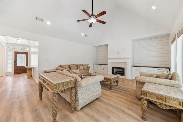 22313 Baneberry Rd, Magnolia, TX 77355 - living room with high vaulted ceiling, ceiling fan, healthy amount of natural light, a fireplace, and light wood finished floors