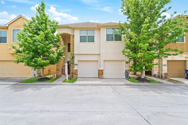 12627 Ashford Shore Dr, Houston, TX 77072 - view of front facade with stucco siding, stone siding, driveway, and an attached garage