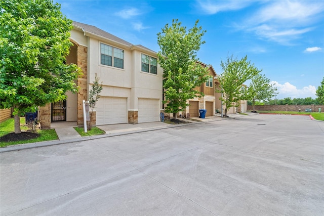 12627 Ashford Shore Dr, Houston, TX 77072 - multi unit property with stucco siding, stone siding, an attached garage, and driveway
