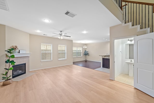 12627 Ashford Shore Dr, Houston, TX 77072 - unfurnished living room with a fireplace, a ceiling fan, recessed lighting, light wood-style floors, and baseboards