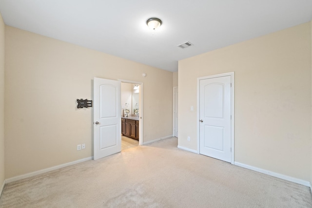 12627 Ashford Shore Dr, Houston, TX 77072 - unfurnished bedroom with light carpet, baseboards, and ensuite bath