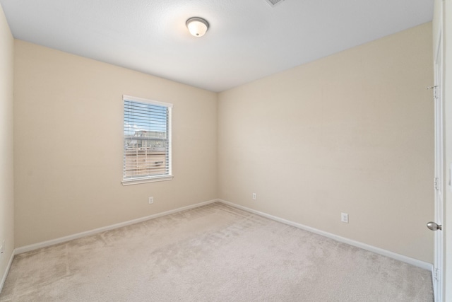 12627 Ashford Shore Dr, Houston, TX 77072 - spare room featuring light carpet and baseboards