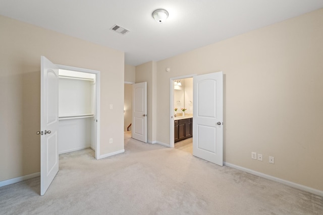 12627 Ashford Shore Dr, Houston, TX 77072 - unfurnished bedroom with light carpet, baseboards, a closet, and a walk in closet