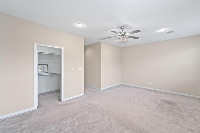 12627 Ashford Shore Dr, Houston, TX 77072 - unfurnished bedroom with carpet, a walk in closet, baseboards, a ceiling fan, and a closet