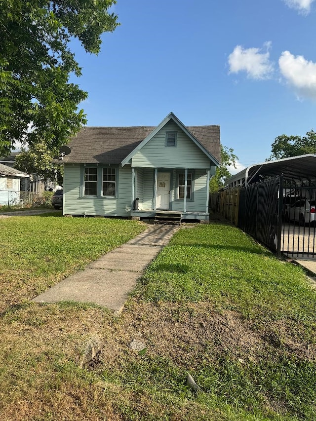 9434 E Ave K, Houston, TX 77012 - view of front of property with a porch, a detached carport, and roof with shingles