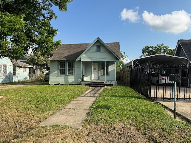 9434 E Ave K, Houston, TX 77012 - view of front of home featuring a carport, a porch, and a shingled roof