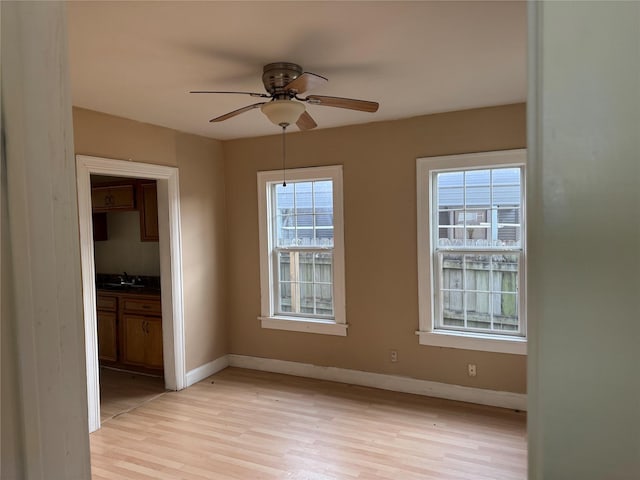 9434 E Ave K, Houston, TX 77012 - empty room featuring light wood finished floors, ceiling fan, and baseboards