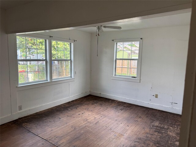 9434 E Ave K, Houston, TX 77012 - empty room with dark wood-type flooring, ceiling fan, and baseboards
