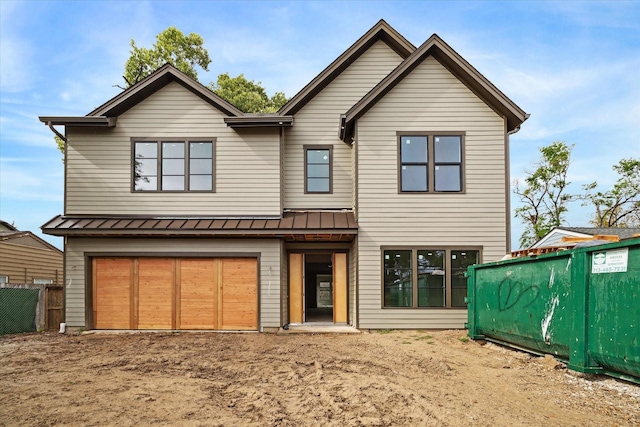 1710 Ebony Ln, Houston, TX 77018 - view of front of home with a standing seam roof, metal roof, a garage, and dirt driveway