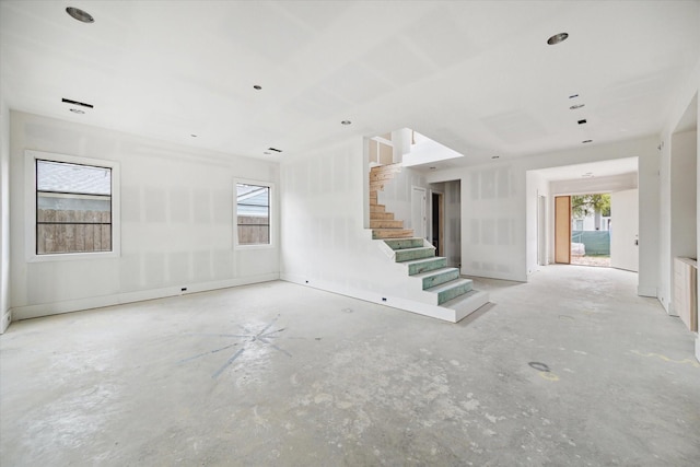 1710 Ebony Ln, Houston, TX 77018 - unfurnished living room with stairway and unfinished concrete flooring