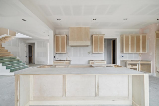 1710 Ebony Ln, Houston, TX 77018 - kitchen with light brown cabinets, premium range hood, a kitchen island, and recessed lighting