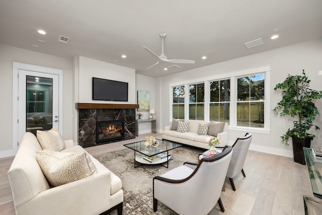 1710 Ebony Ln, Houston, TX 77018 - living area featuring light wood-style flooring, a premium fireplace, a ceiling fan, recessed lighting, and baseboards