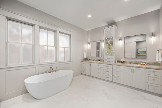 1710 Ebony Ln, Houston, TX 77018 - full bathroom with double vanity, a freestanding bath, marble finish floors, and recessed lighting