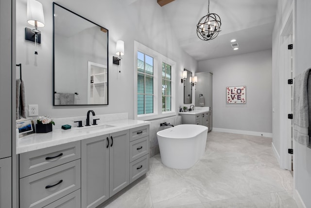 1710 Ebony Ln, Houston, TX 77018 - bathroom with two vanities, a freestanding bath, a chandelier, and baseboards