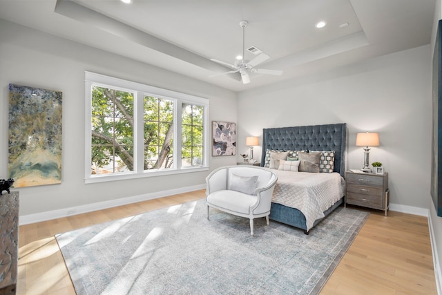 1710 Ebony Ln, Houston, TX 77018 - bedroom featuring a tray ceiling, wood finished floors, baseboards, recessed lighting, and ceiling fan