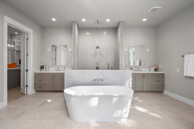 1710 Ebony Ln, Houston, TX 77018 - bathroom featuring two vanities, a freestanding tub, a tile shower, baseboards, and recessed lighting