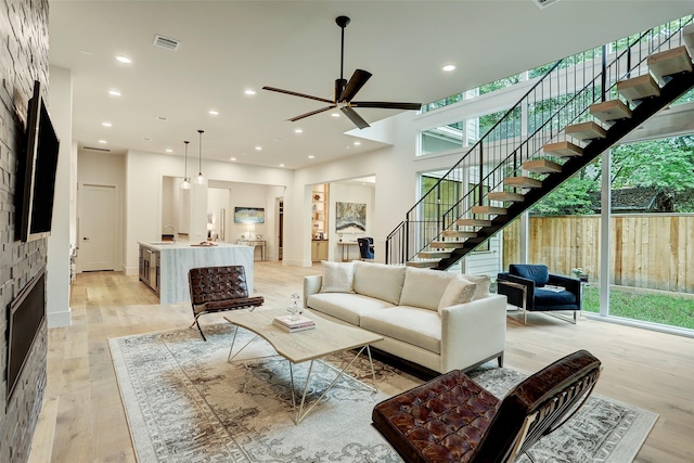 1710 Ebony Ln, Houston, TX 77018 - living area with stairs, ceiling fan, light wood-style floors, recessed lighting, and a fireplace