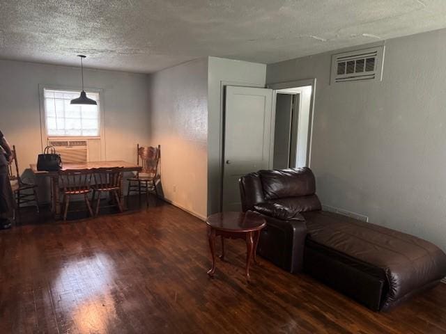 5111 Kelso St, Houston, TX 77021 - sitting room featuring a wall mounted air conditioner, wood finished floors, and a textured ceiling