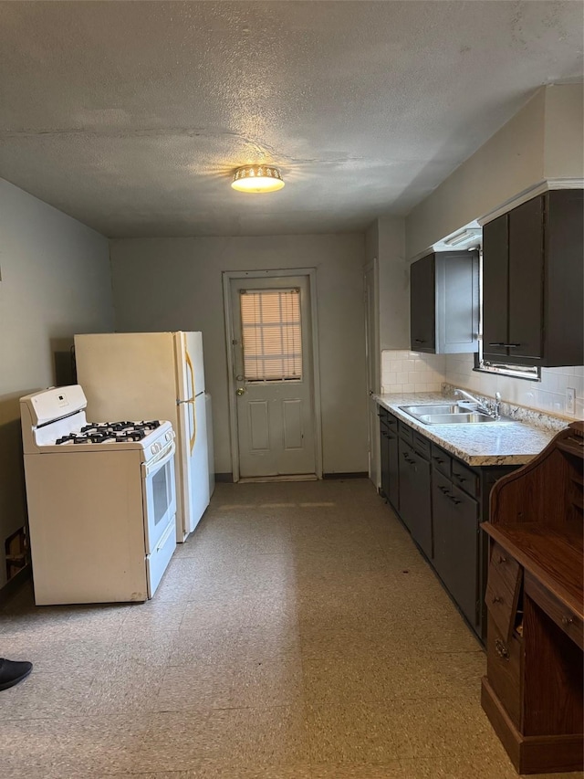 5111 Kelso St, Houston, TX 77021 - kitchen featuring white range with gas stovetop, a sink, light countertops, a textured ceiling, and decorative backsplash