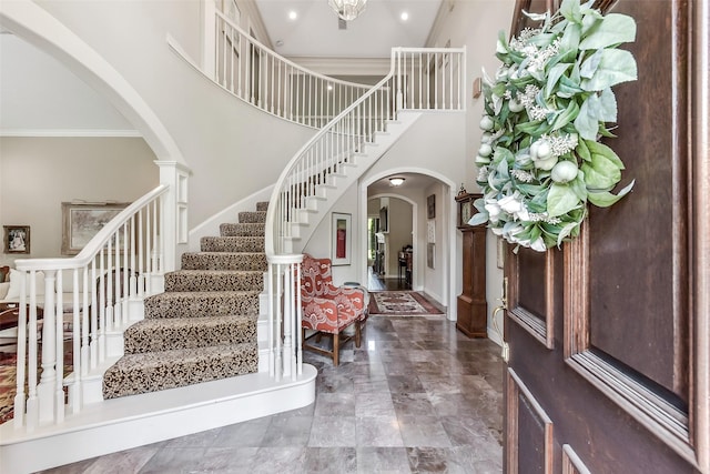 6 Woodsborough Cir, Houston, TX 77055 - foyer featuring arched walkways, crown molding, stairs, a towering ceiling, and recessed lighting