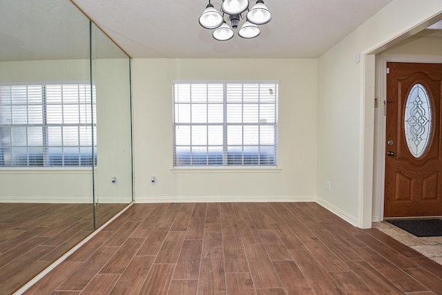 4026 Almond Lake Dr, Houston, TX 77047 - entryway featuring a chandelier, wood finished floors, and baseboards